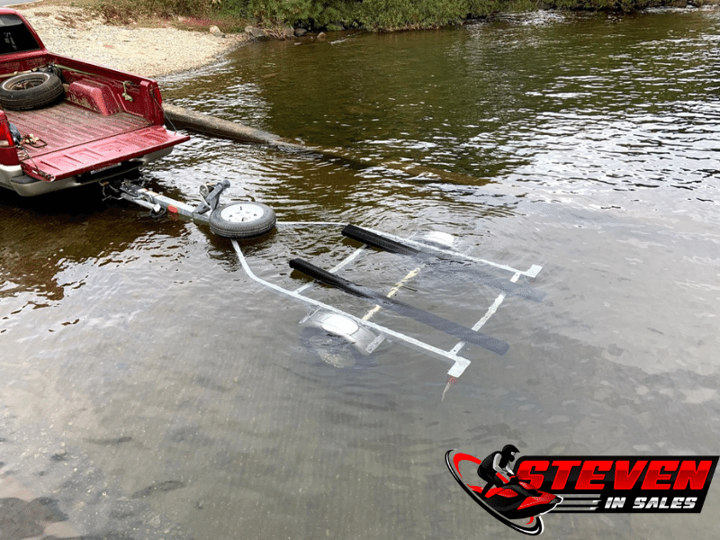 Empty MOVE 1 galvanized trailer backed into the water